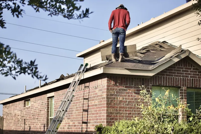Professional roofer working on a residential roof in Farragut Square